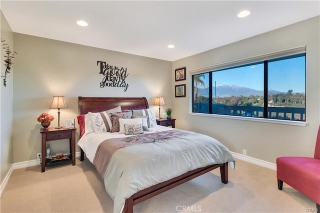 carpeted bedroom featuring baseboards and recessed lighting