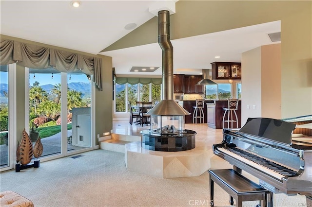 living room featuring vaulted ceiling, recessed lighting, visible vents, and light colored carpet