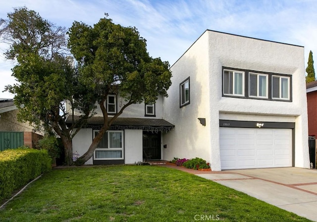 view of front of home with driveway, an attached garage, a front lawn, and stucco siding