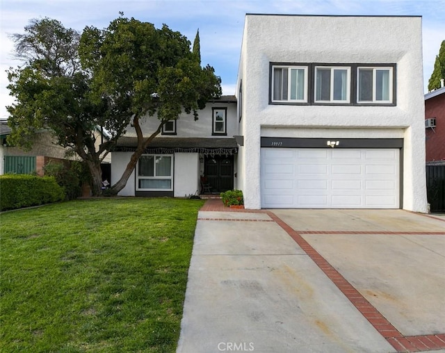 view of front facade with an attached garage, a front lawn, concrete driveway, and stucco siding