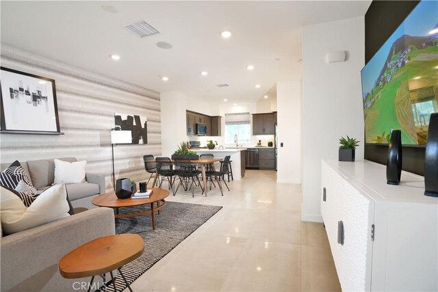 living room featuring light tile patterned floors, visible vents, and recessed lighting