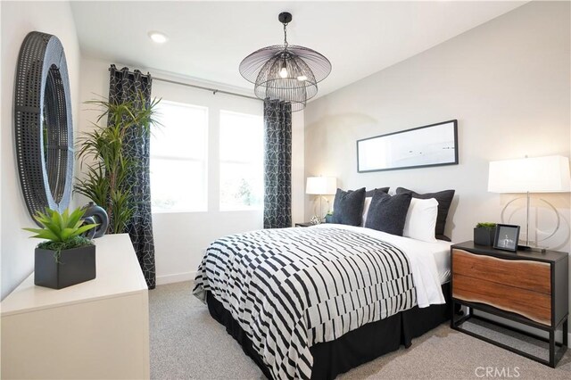 carpeted bedroom featuring baseboards