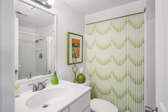 bathroom with visible vents, vanity, and toilet