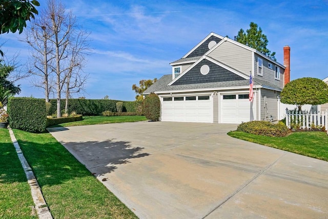 garage featuring driveway and fence