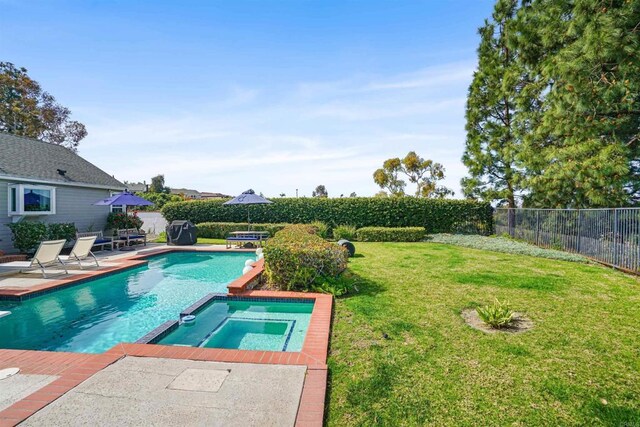 view of swimming pool featuring a pool with connected hot tub, a fenced backyard, a lawn, and a patio