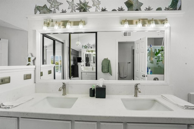 bathroom featuring double vanity, a sink, and visible vents