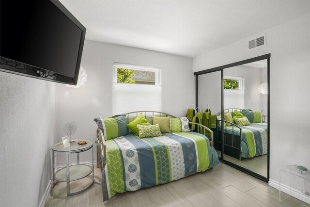 bedroom featuring baseboards and visible vents