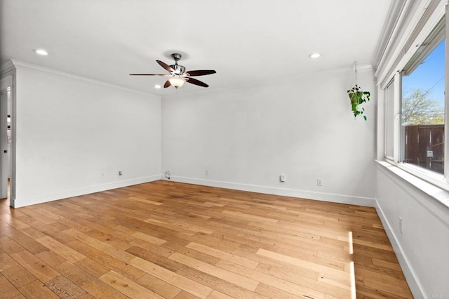 unfurnished room with crown molding, a ceiling fan, light wood-style floors, and baseboards