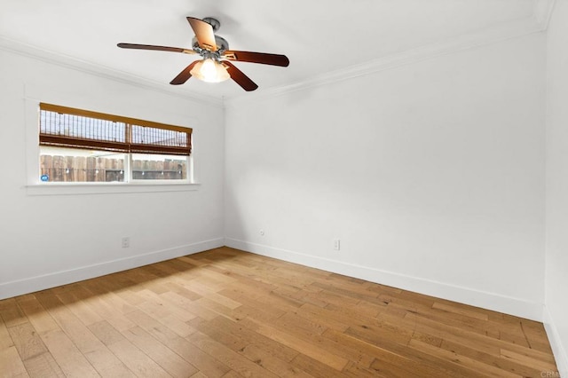 unfurnished room featuring light wood-style flooring, crown molding, and baseboards