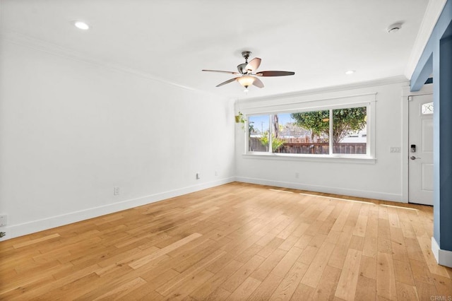 unfurnished room featuring ceiling fan, baseboards, light wood-style floors, and ornamental molding