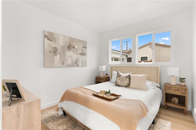 bedroom featuring light wood-type flooring and baseboards