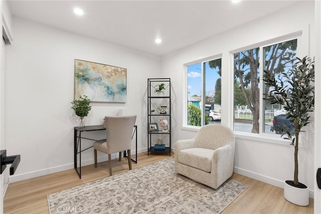 living area with recessed lighting, wood finished floors, and baseboards