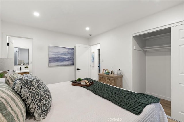 bedroom with recessed lighting, a closet, and wood finished floors