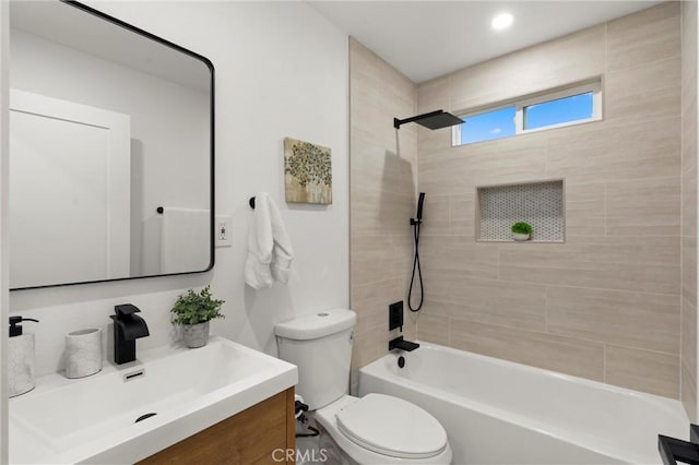 full bathroom featuring vanity, bathtub / shower combination, and toilet