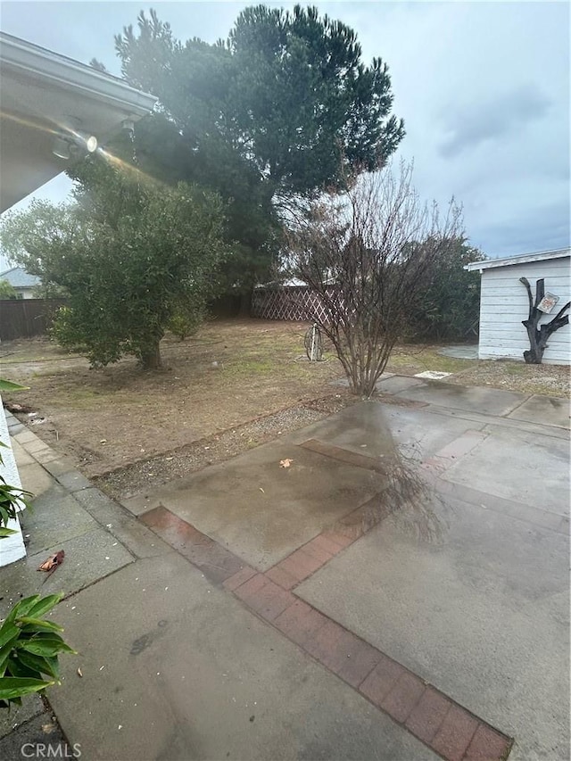 view of yard featuring a patio and fence