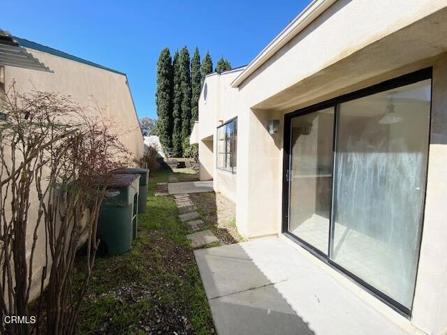 view of side of home with stucco siding