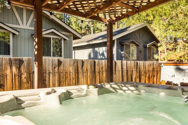 exterior space featuring fence and a hot tub