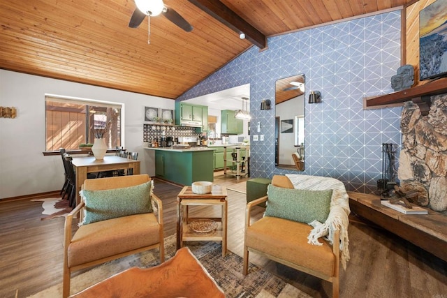 sitting room with light wood finished floors, lofted ceiling with beams, a ceiling fan, wooden ceiling, and baseboards