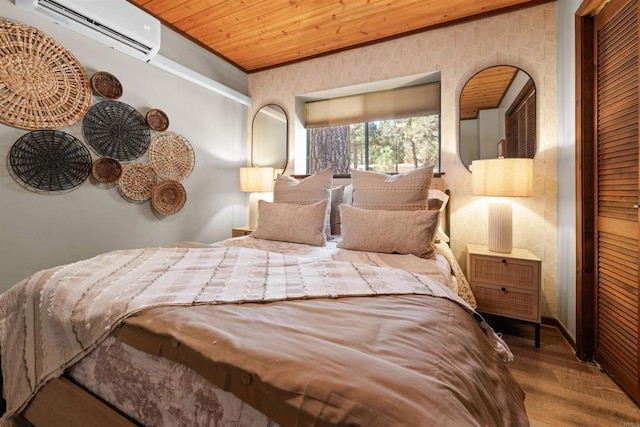 bedroom with crown molding, a closet, wood finished floors, wooden ceiling, and a wall mounted air conditioner