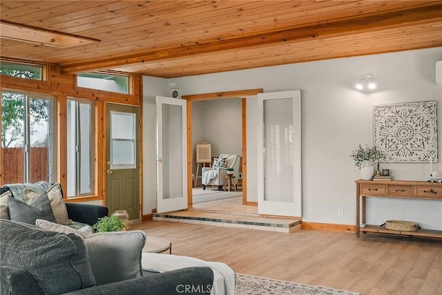 living area with wood ceiling, french doors, baseboards, and wood finished floors