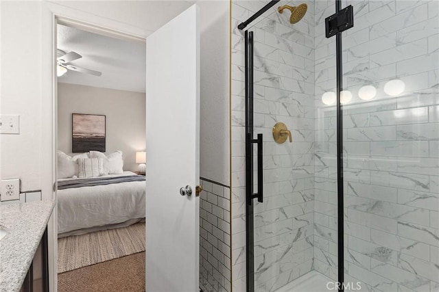 ensuite bathroom featuring a stall shower, ceiling fan, vanity, and ensuite bathroom