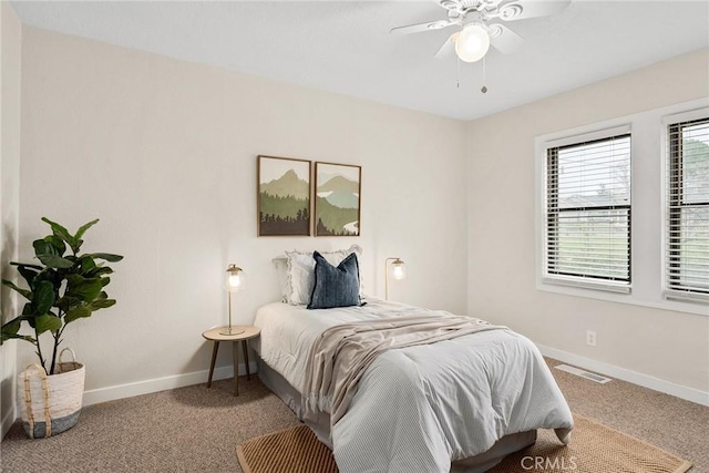 bedroom featuring a ceiling fan, carpet, visible vents, and baseboards