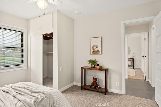 bedroom with light carpet, a closet, and baseboards