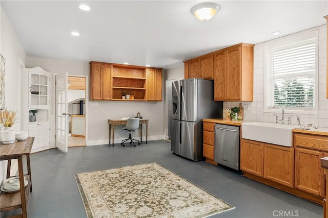 kitchen with open shelves, tasteful backsplash, appliances with stainless steel finishes, and light countertops