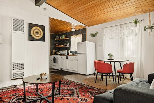 living room featuring lofted ceiling with beams, wooden ceiling, dark wood-style floors, and a heating unit