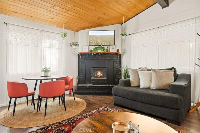 sitting room with lofted ceiling, wood ceiling, a fireplace, and wood finished floors