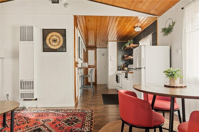 kitchen with lofted ceiling, wooden ceiling, dark wood-type flooring, a heating unit, and white appliances