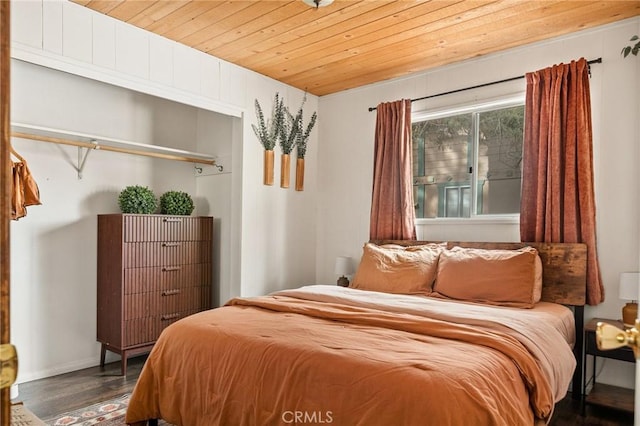 bedroom with wooden ceiling and wood finished floors