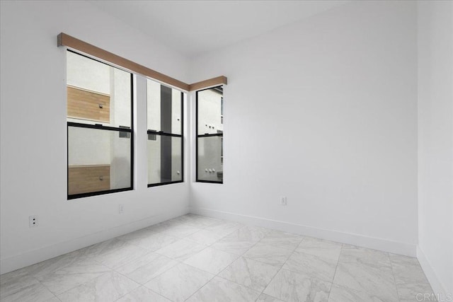 spare room with baseboards