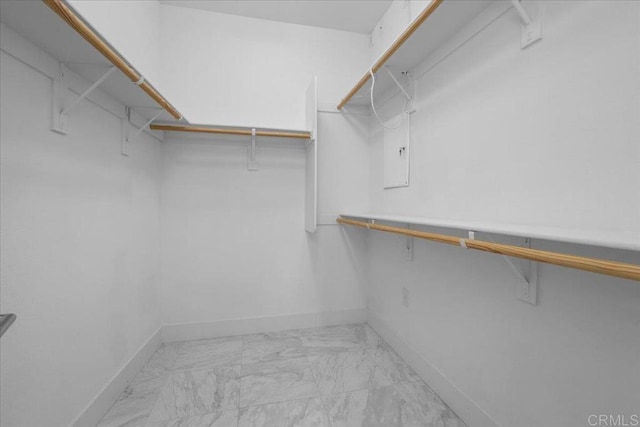 spacious closet with marble finish floor