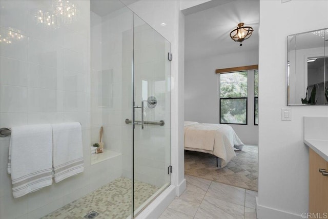 full bath with a shower stall, vanity, and ensuite bathroom