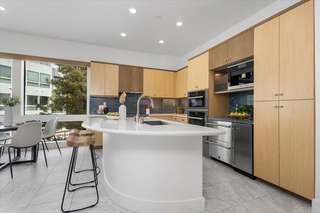 kitchen with stainless steel double oven, tasteful backsplash, recessed lighting, and a sink