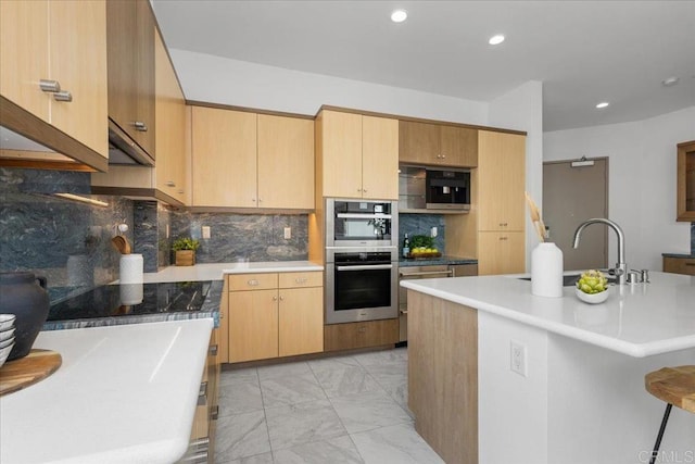 kitchen with recessed lighting, decorative backsplash, marble finish floor, black electric cooktop, and a sink