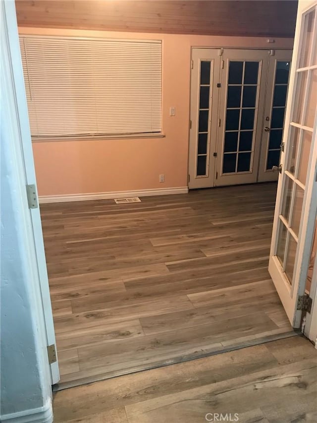 unfurnished room featuring baseboards and wood finished floors