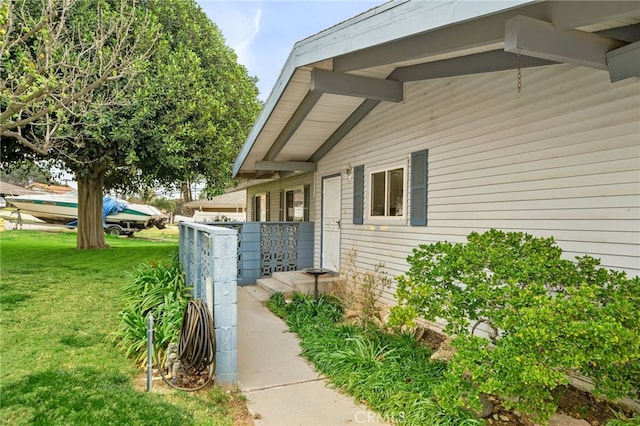 entrance to property featuring a yard