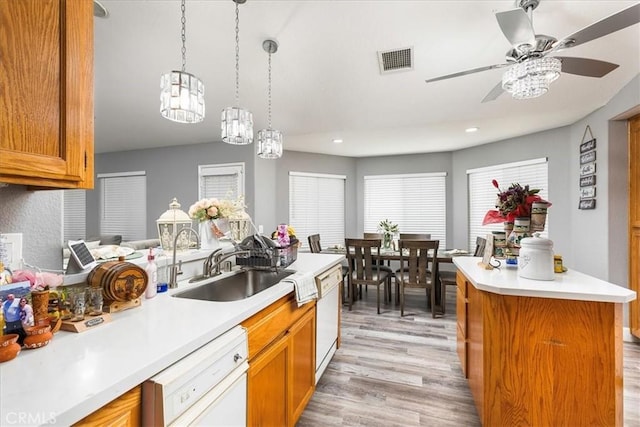 kitchen with dishwasher, visible vents, and brown cabinets