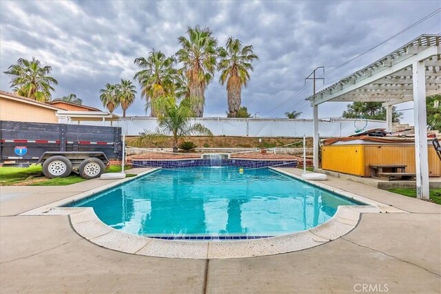 view of pool featuring a hot tub, fence, and a fenced in pool