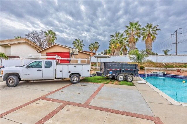 exterior space with fence and a fenced in pool