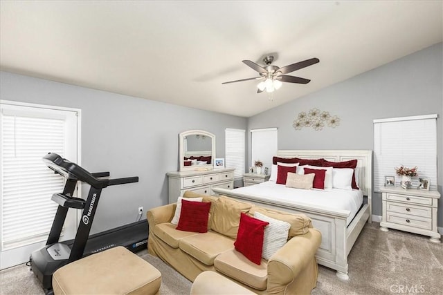 bedroom featuring lofted ceiling, light carpet, ceiling fan, and multiple windows