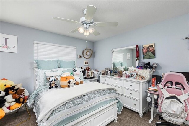 bedroom with a ceiling fan and carpet flooring