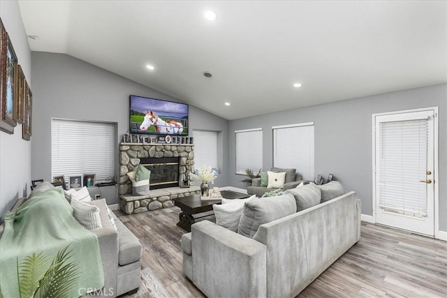 living room with lofted ceiling, a fireplace, wood finished floors, and recessed lighting