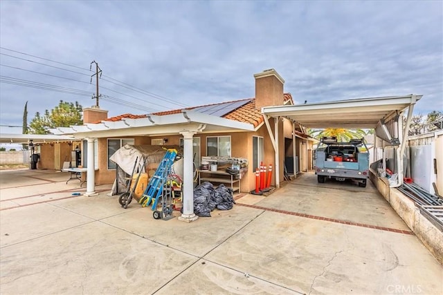 exterior space featuring a carport and concrete driveway