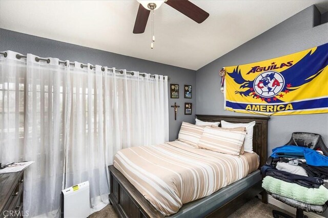 bedroom with lofted ceiling and a ceiling fan