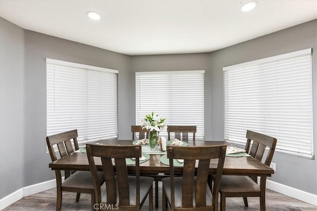 dining space featuring recessed lighting, baseboards, and wood finished floors