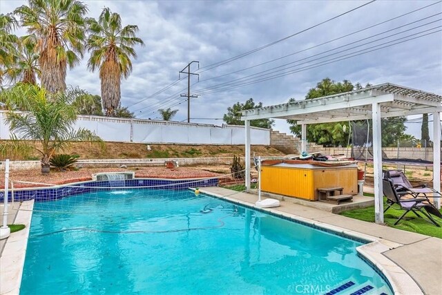 view of pool with a pergola, a fenced backyard, a fenced in pool, and a hot tub