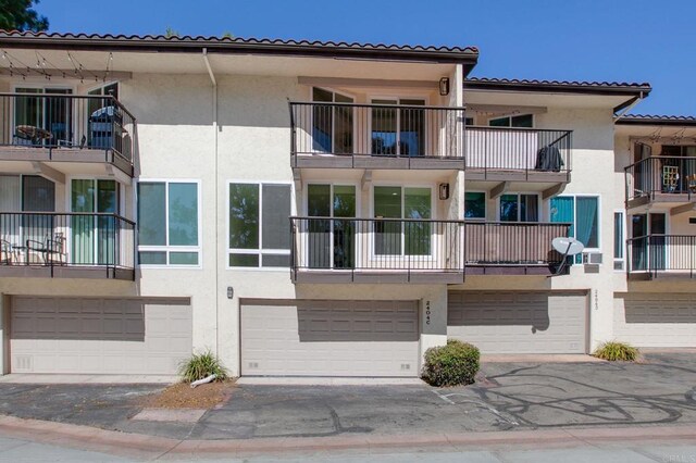 view of property featuring a garage and driveway